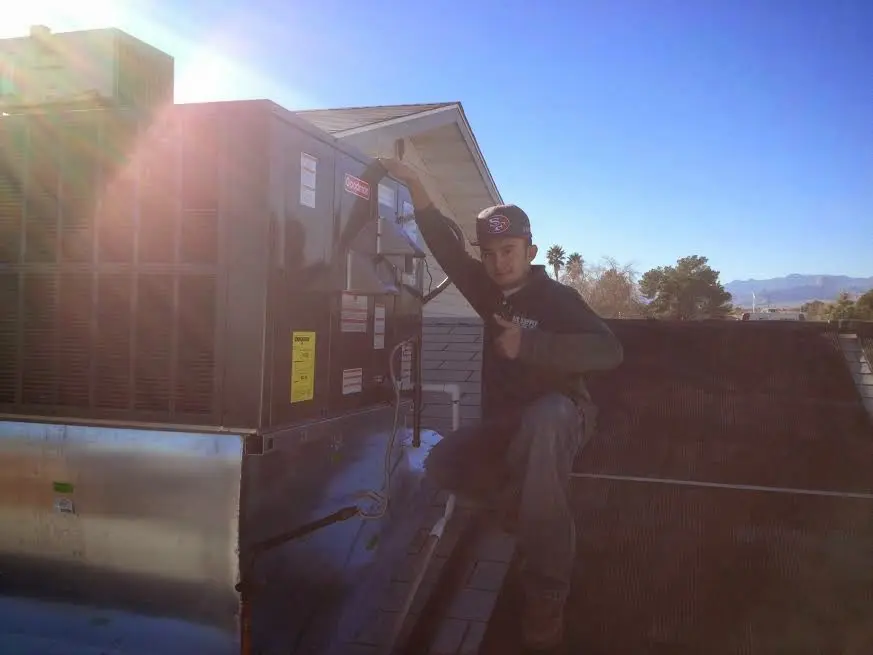 HVAC technician performing AC Tune-Up on a rooftop unit in Sausalito